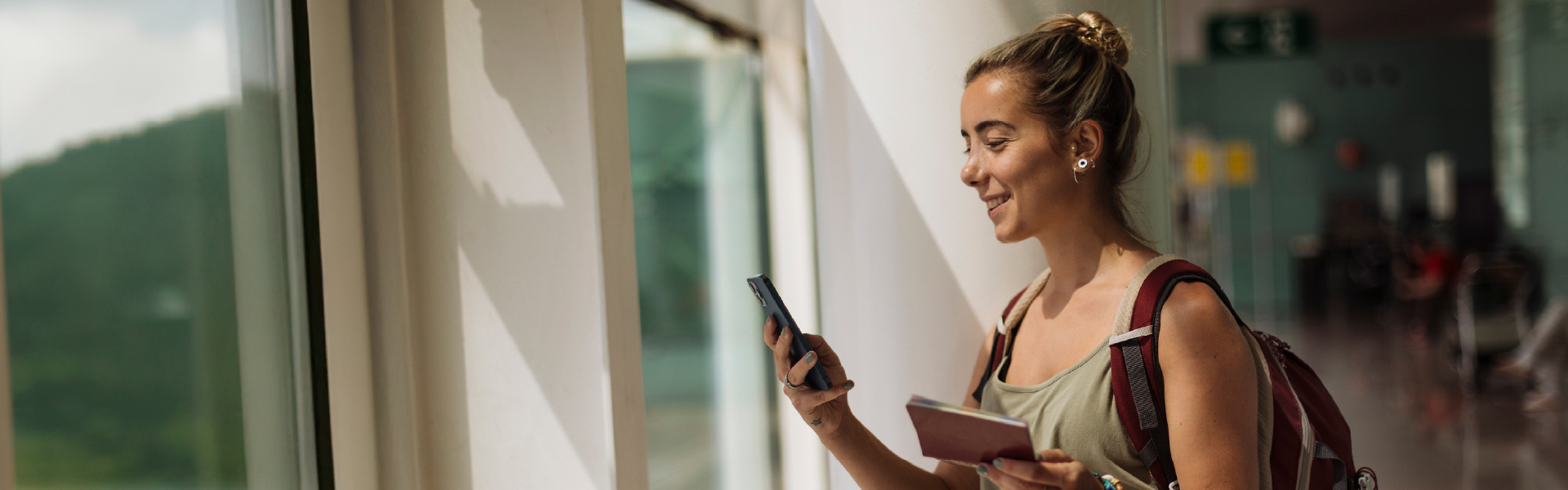 Centric_SharedBranching_Web1920x600_0425 Woman looking at mobile phone and smiling