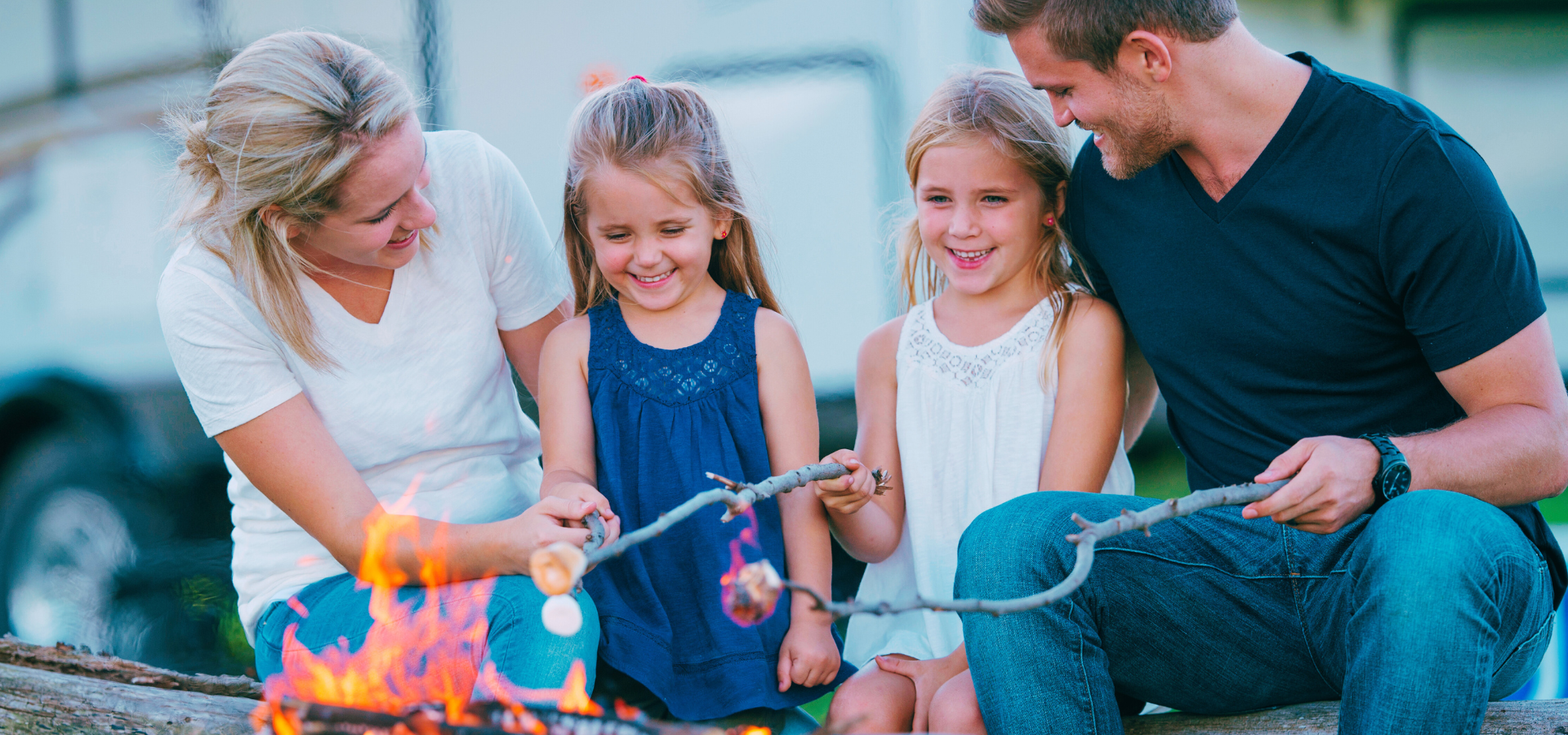 RV Loans Family roasting marshmallows over a fire at a campsite